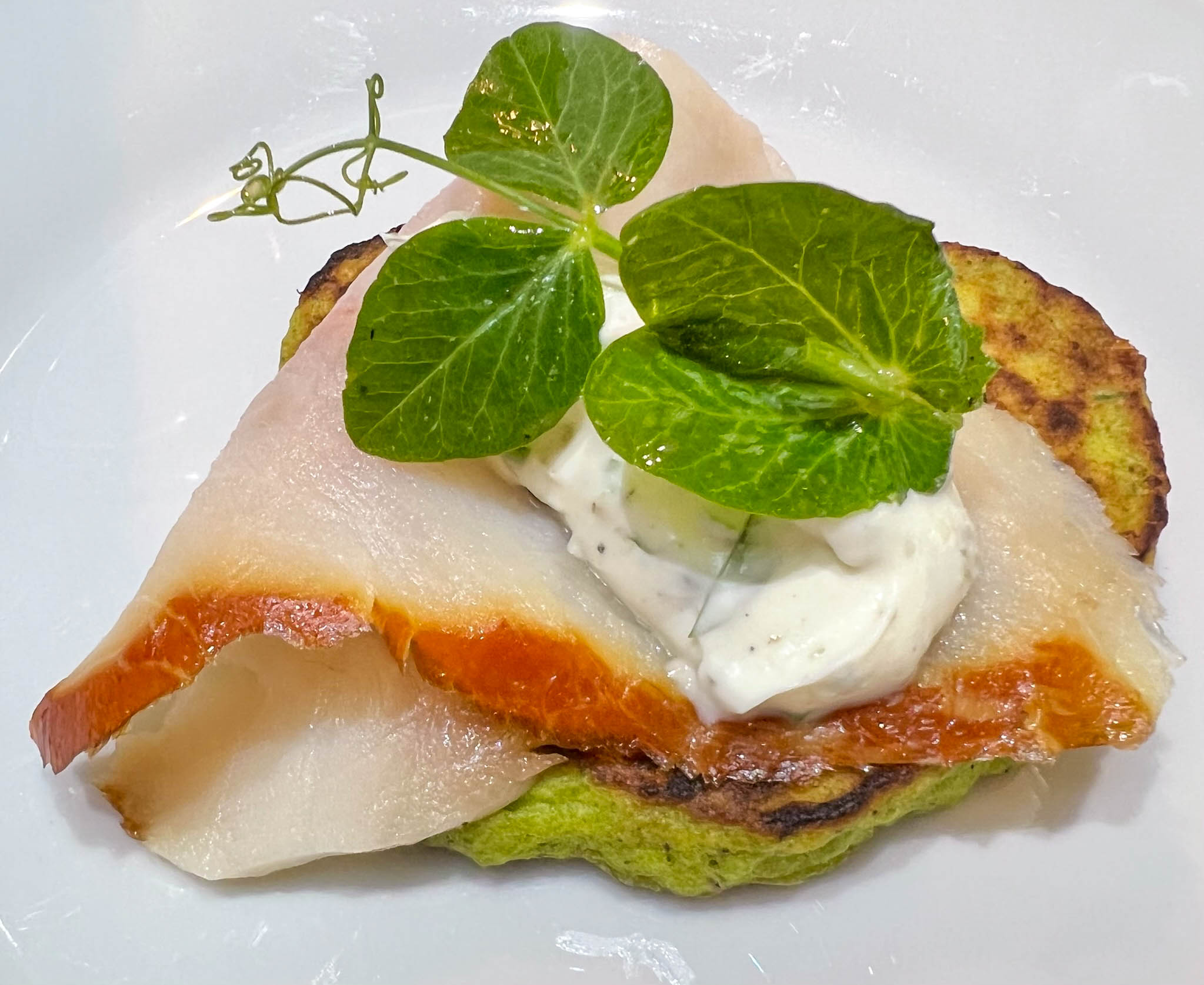 Smoked sturgeon with sweet pea pancakes, and herbed crème fraiche